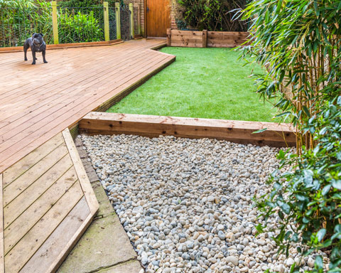section of a residntial garden, yard with wooden decking